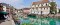 Vue sur l'eau turquoise de la rivière Thiou à Annecy avec ses bâtiments rustiques et ses rues piétonnes